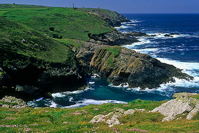 ENG: South West Region, Cornwall, Cornwall AONB, Penwith Peninsula, Pendeen Watch, View south along the cliffs, with the abandoned Geevor tin mine ruins in the background [Ask for #268.221.]