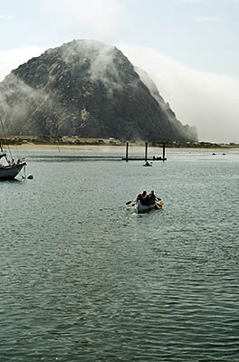 CA: South Coast Region, San Luis Obispo County, Pacific Coast Area, City of Morro Bay, Embarcadero, Canoeists paddle towards Morro Rock, shrowded in clouds [Ask for #271.015.]