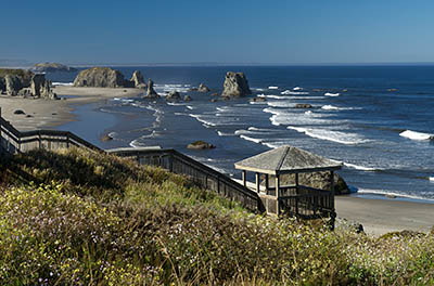 OR: South Coast Region, Coos County, Bandon Area, South Beaches, Cocquille Point, Stairs lead down a grassy cliff to a sand beach spotted with large hoodoos [Ask for #274.346.]
