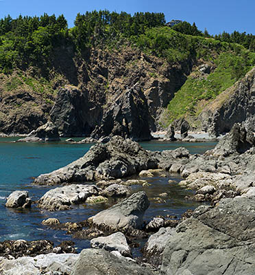 OR: South Coast Region, Curry County, North Coast, Port Orford Area, Town of Port Orford, Port Orford Marina, Sea cliffs by the town's harbor, with Port Orford Head in bkgd [Ask for #274.402.]