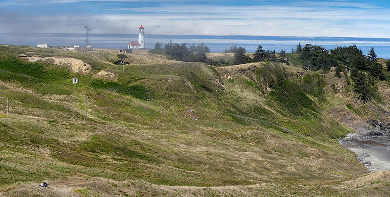 OR: South Coast Region, Curry County, North Coast, Cape Blanco Area, Cape Blanco State Park, View of the Cape Blanco Lighthouse atop grassy cliffs as fog rolls in. [Ask for #274.668.]