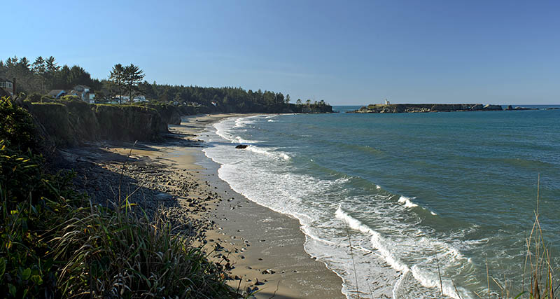 OR: Coos County, Coos Bay Area, Cape Arago Parks, Yoakam Point State Park, View from the sea cliffs, over the beach below, towards Cape Arago Lighthouse. [Ask for #276.151.]