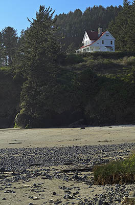 OR: South Coast Region, Lane County, Pacific Coast, Cape Perpetua Area, Heceta Head, Lighthouse Keepers Cottage, now a B&B, viewed from the beach below [Ask for #276.558.]