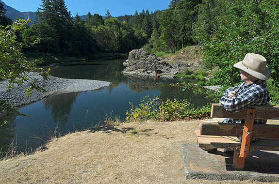 OR: Coos County, Coast Range, Coquille River Drainage, Powers Community. Self-portrait. Orchard Park. A park bench overlooks the swimming hole on the South Fork Coquille River, in a rock-lined gorge. [Ask for #277.057.]