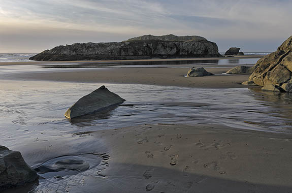OR: Coos County, Bandon Area, South Beaches, Devils Kitchen State Wayside. Sunset beach view towards Haystack Rock on receding tide [Ask for #278.033.]