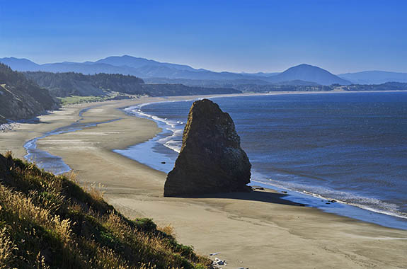 OR: South Coast Region, Curry County, North Coast, Cape Blanco Area, Cape Blanco State Park, Sea stack on a deserted sand beach [Ask for #278.369.]